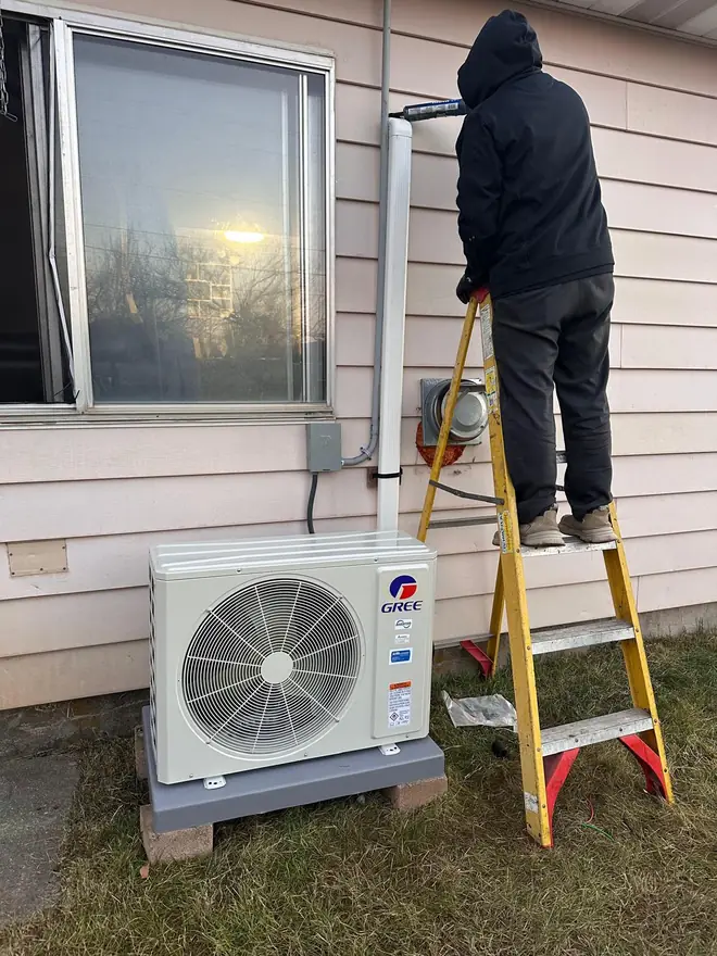 Mountain Star technician installing a new outdoor AC condenser unit